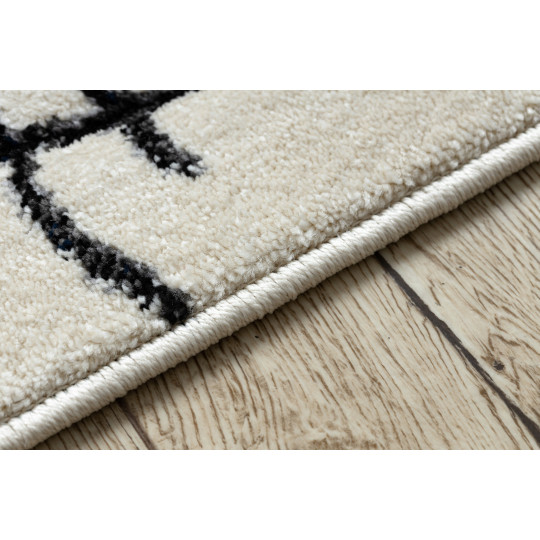 Un covor de calitate pentru copii de culoare bej cu un urs.