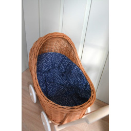 Cărucioare din rattan pentru copii, de culoare maro, cu o păturică albastră.