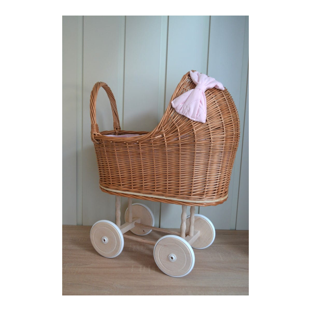 Cărucior pentru păpuși de culoare marron cu păturică roz și fundiță