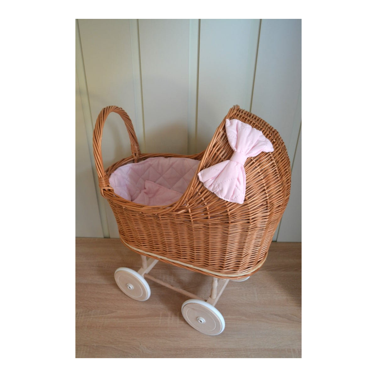 Cărucior pentru păpuși de culoare marron cu păturică roz și fundiță