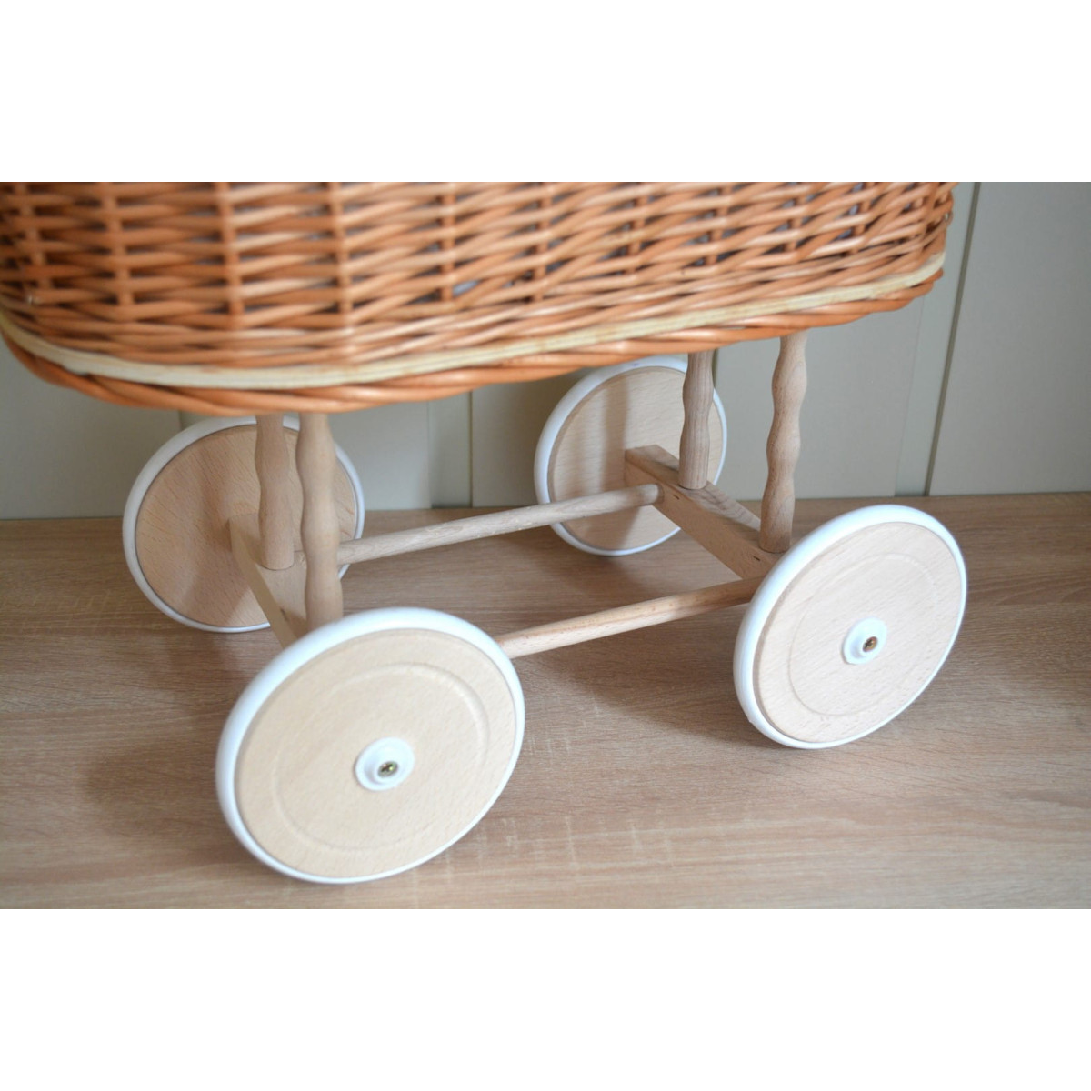 Carucior din material natural cu volan roz.