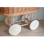 Carucior din material natural cu volan roz.